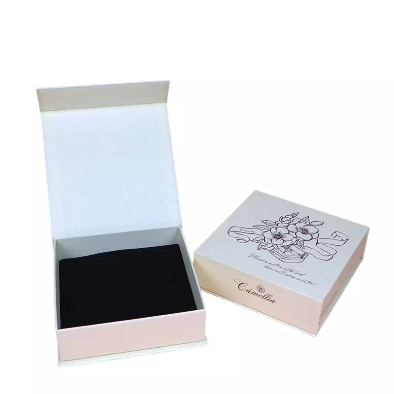 This soft pale pink custom rigid gift box features steady magnetic closure and soft black flocked inner liner to protect jewelry and cosmetics. It supports custom floral graphic and brand text printing on the matte surface. Sturdy rigid construction keeps items safe during transit, perfect for feminine luxury retail and holiday gift wrapping.