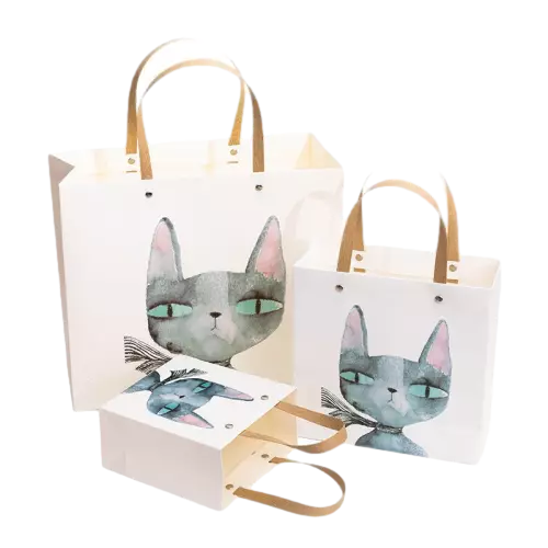 These charming coated art paper bags are printed with delicate watercolor cat artwork on smooth white surface. They are equipped with durable flat paper handles fastened with metal rivets to improve loading strength. Three different sizes are available to meet diverse packaging requirements. The glossy coated paper brings bright and clear printing performance. You can add unique custom logos and illustrations for brand building. Perfect for toy stores children gift shops birthday party favors and boutique retail product packaging. Wholesale bulk orders are welcomed.