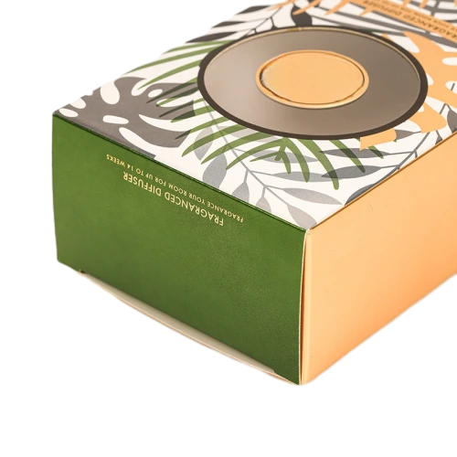 These premium cardboard packaging boxes are specially designed for reed diffuser fragrance goods. The top surface features exquisite tropical plant leaf printing paired with a round transparent viewing window, and the side panel adopts elegant gold toned paper finish. Multiple box shapes including upright long boxes and flat horizontal boxes are available. High quality thick paper provides sturdy outer protection, custom made prints, window sizes and box dimensions are supported, ideal for home aromatherapy diffuser packaging, scented gift sets and large quantity wholesale orders.