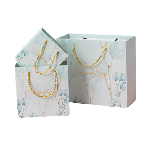 These delicate coated art paper bags are decorated with soft watercolor leaf prints on fresh light green background, matched with stylish golden twisted rope handles for comfortable carrying. Multiple sizes are available to fit different skincare and cosmetic products. The smooth coated paper surface delivers bright high definition printing results. Custom logo and artwork printing service is supported for brand display. With elegant fresh appearance, these bags are ideal packaging choices for beauty shops cosmetic boutiques and gift giving. Large quantity wholesale service is available.
