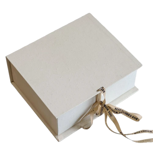 These minimalist sliding drawer custom rigid gift boxes are made of delicate textured off white paper and available in square short rectangle and tall rectangle dimensions. Each box comes with detachable beige satin ribbon printed with BEST WISHES FOR YOU which can be tied into elegant bows for decoration. The durable thick cardboard structure resists bending and abrasion. Custom ribbon text outer box logo printing and bespoke sizes are supported well suited for jewellery perfume small sized cosmetics hand made presents and holiday gift set wholesale orders.