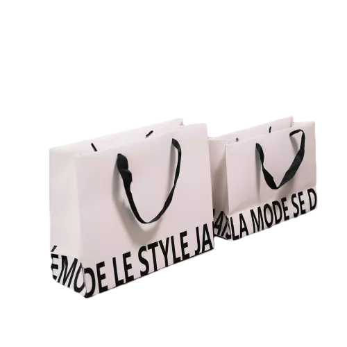 These stylish special craft paper bags feature clean offwhite matte surface with eye catching bold black letter print along the bag bottom. Premium black ribbon handles deliver soft comfortable touch and strong load bearing capacity. Thick craft paper material maintains firm shape while carrying goods. Two different sizes are available to satisfy varied packaging requirements. Full custom printing service can print your unique brand logo slogan and text content. These modern shopping bags fit perfectly for clothing stores fashion boutiques and retail brand gift packaging. Wholesale bulk orders are welcomed.