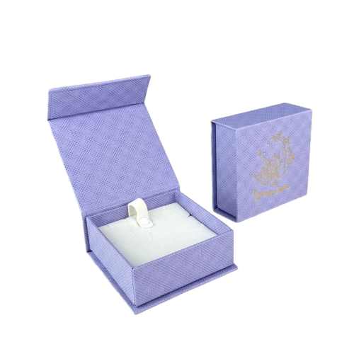 This elegant lavender custom rigid box is made of thick hardboard covered with delicate crossgrain textured paper. It comes with magnetic flip lid for convenient opening and tight sealing. The soft white foam insert with ring holder securely fixes rings earrings and tiny ornaments. Custom gold foil printed logo and decorative patterns can be added on the outer surface to enhance brand charm. The robust rigid shell provides reliable protection for fine jewelry during transportation and shop display. It is a wonderful packaging solution for jewelry retailers and large volume wholesale orders.