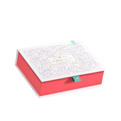 This elegant two tone custom rigid box is constructed from thick durable hardboard. The top lid features delicate hand drawn leaf sketch artwork while the box base comes in vibrant coral red finish. A small fabric pull tab is fixed on the front for effortless opening. Custom gold foil label and brand text can be printed on the lid surface. The roomy inner compartment works perfectly for storing notecards greeting cards stationery sets and small paper gifts. Its sturdy rigid structure protects contents well during transport and retail shelf display. It is a refined packaging choice for stationery brands and large volume wholesale orders.