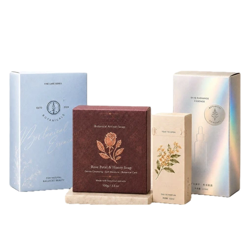 This multi size series of custom cardboard boxes uses diversified premium paper materials including matte coated paper and iridescent holographic paper. Boxes are available in square and tall vertical shapes to fit handmade soap perfume bottles and facial essence. Exquisite embossed flower patterns cursive brand text and tear strip opening structure can be added as customized options. You can freely adjust surface finish color schemes logo layout and product descriptions for your full botanical skincare line. Thick high grade cardboard provides excellent protection for beauty goods during transport and high end retail shelf display. It is an elegant natural themed packaging solution for cosmetic suppliers and large volume wholesale orders.