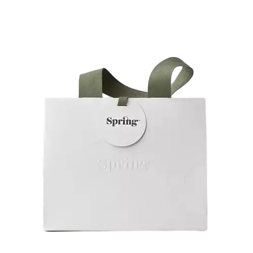 These high end special craft paper bags are produced with premium matte white paper and matched with elegant army green wide fabric ribbon handles. Delicate debossed logo creates subtle textured effect on the bag surface and a separate round paper hang tag is attached for brand display. The spacious horizontal shape provides enough room for clothes cosmetics and various retail products. Thick sturdy paper keeps the tote standing firmly without deformation. You can customize embossed patterns printed logos and hang tag contents to meet unique brand requirements. These stylish paper bags are great packaging choices for clothing stores cosmetic shops and boutique gift delivery. Wholesale bulk orders are welcomed.