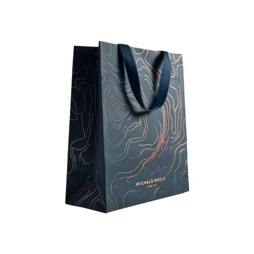 These premium luxury paper gift bags are made of thick dark green paper decorated with elegant gold foil contour line patterns. Smooth navy blue fabric ribbon handles deliver comfortable grip and strong weight bearing capacity. Hot stamping gold craft brings shiny metallic visual effect to upgrade your brand grade. The upright vertical structure offers large inner space suitable for wine perfume skincare sets and high end gift items. You can customize foil printed logo brand slogan and exclusive artwork on the bag surface. These stylish darktoned tote bags are excellent packaging choices for luxury boutiques wine shops and premium corporate gifts. Wholesale bulk orders are welcomed.