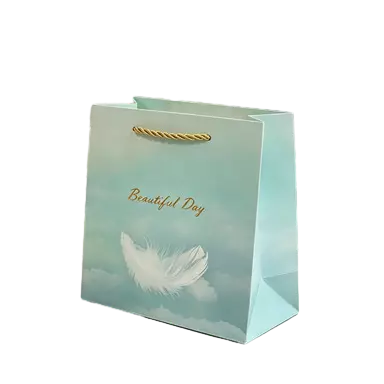 These fresh style gift paper bags are crafted from thick durable paper printed with soft mint green sky background and elegant white feather artwork. Premium golden twisted paper rope handles deliver comfortable touch and reliable load bearing performance. Hot stamped golden text adds delicate festive charm, suitable for birthday gifts wedding favors small party souvenirs and daily retail products. The smooth bag surface supports full custom printing of unique logo brand slogan and decorative patterns. These lightweight elegant tote bags are great packaging selections for gift shops boutique stores and all kinds of festive occasions. Wholesale bulk orders are welcomed.