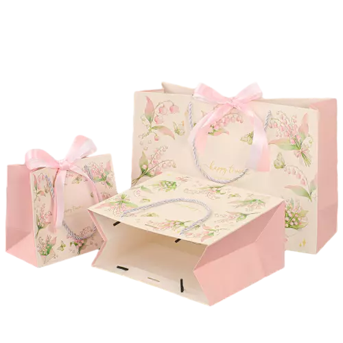 These fresh floral gift paper bags are made of thick high quality paper printed with elegant lily of the valley flowers and lovely butterfly patterns. Soft twisted paper rope handles provide comfortable grip and strong load bearing performance. Beautiful pink satin bow decoration creates a warm sweet atmosphere for gift giving. Multiple sizes are offered to satisfy different packaging needs for small accessories cosmetics wedding favors and birthday surprises. The smooth bag surface supports full custom printing of unique logo brand slogan and decorative artwork. These graceful tote bags are great packaging choices for gift shops florists and all kinds of festive occasions. Wholesale bulk orders are welcomed.