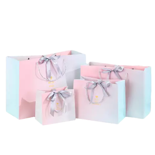 These sweet gradient gift paper bags are made of thick durable paper with elegant pink and white gradient surface printed with delicate golden heart patterns. Strong silver twisted paper rope handles offer comfortable touch and reliable load bearing performance. Graceful grey satin bow decoration adds gentle romantic charm for gift giving. Multiple available sizes meet different packaging demands for cosmetics clothing birthday gifts wedding favors and retail goods. The smooth bag surface supports full custom printing of unique logo brand slogan and decorative artwork. These soft stylish tote bags are perfect packaging selections for boutique shops gift stores and various festive occasions. Wholesale bulk orders are welcomed.