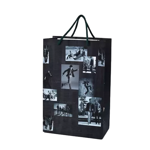 These stylish gift paper bags are constructed from thick heavy duty paper finished with a sleek black background and artistic black and white snapshot collage print. Durable dark green twisted paper rope handles deliver solid load bearing capacity and comfortable grip during carrying. The fashionable photo collage design fits perfectly for fan gifts trendy merchandise souvenirs and youth oriented retail products. The smooth outer surface supports full custom printing of unique logo brand slogan and personalized photo artwork. These cool modern tote bags are great packaging solutions for souvenir shops fan stores and fashion retail businesses. Wholesale bulk orders are welcomed.