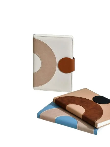 These chic hardcover notebooks feature a modern two-tone geometric arc spliced PU leather cover with a secure magnetic buckle closure, blending minimalist aesthetic with practical functionality. The thick premium inner pages deliver smooth writing experience and effectively prevent ink bleedthrough, perfect for daily planning, meeting minutes and personal journaling. Neat stitched edges reinforce durability for long term daily carry. The cover supports custom logo and pattern printing, making it an ideal corporate stationery gift, suitable for office supply, boutique retail and bulk wholesale procurement.