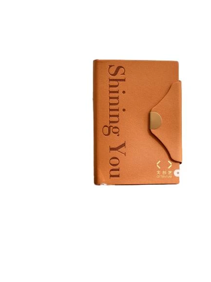 These elegant hardcover notebooks adopt premium textured PU leather covers with delicate embossed letter details and a unique envelope style flap fitted with gold magnetic buckle, presenting a minimalist luxury aesthetic suitable for both business and personal scenarios. Built with a practical ribbon bookmark for quick page locating and thick premium lined inner pages that ensure smooth writing performance and effectively prevent ink bleedthrough, they are perfect for work planning, meeting minutes and daily journaling. The slim portable design fits easily into handbags for on the go use, and the cover supports custom logo printing to satisfy brand personalization demands. They serve as high-end stationery gifts for corporate clients and employees, ideal for boutique retail and bulk wholesale procurement.