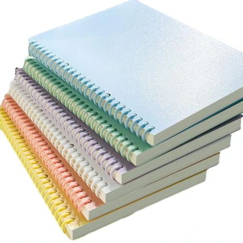 This plastic coil spiral bound notebook comes in multiple fresh macaron solid color matte covers including sky blue, mint green, soft yellow, pink and lavender. The lightweight smooth plastic spiral ring prevents scratch on hands and enables 180 degree flat opening. High density thick lined inner pages effectively stop ink bleed through. The simple blank cover supports customized printing, suitable for school note taking, workplace memorandums, study planning and daily records. Custom logos and personalized cover patterns are available for bulk wholesale orders.