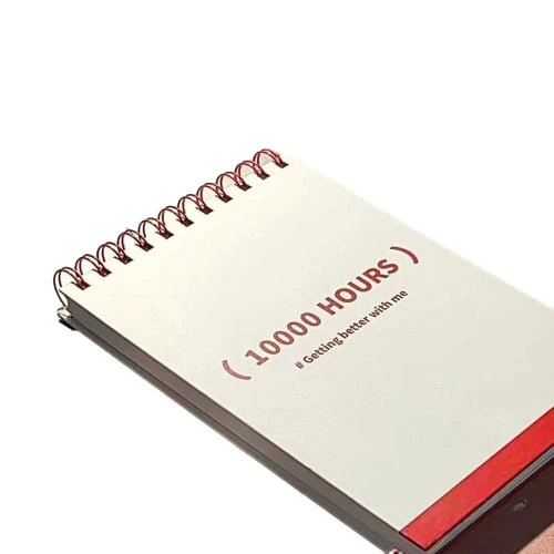 This top coil spiral bound study planner notebook adopts eye catching red metal wire o binding. The outer cover is printed with inspirational 10000 HOURS slogan. Its specially designed interior features grid paper and dedicated timing tracking tables for recording study cycles, daily goals and progress arrangements. Thick smooth writing grid style pages resist ink bleed through. Custom printed cover patterns and brand logo services are available. It suits student exam preparation, habit cultivation, daily task scheduling and large batch wholesale procurement.
