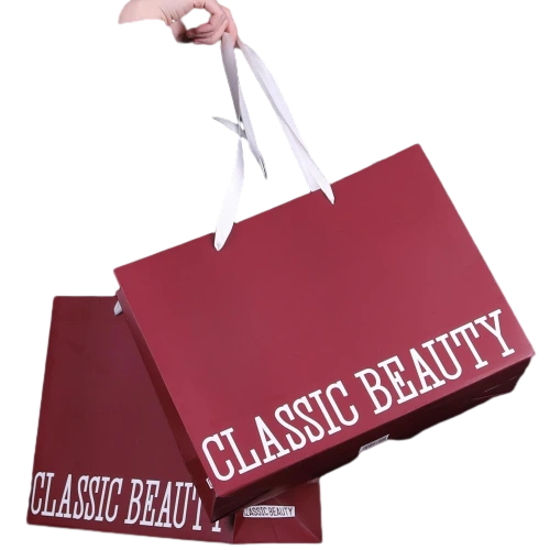 Special Craft Paper Bags feature elegant wine red solid surface printed with bold white CLASSIC BEAUTY letter on the side. White wide ribbon handles are smooth and sturdy for comfortable carrying. Thick premium craft paper keeps the bag rigid and holds shape perfectly. Deep red tone creates classy and romantic atmosphere for gift giving and retail shopping. We support custom bag size base color printed text and brand logo. These paper bags work great for cosmetic stores clothing boutiques birthday gifts and holiday gift sets.
