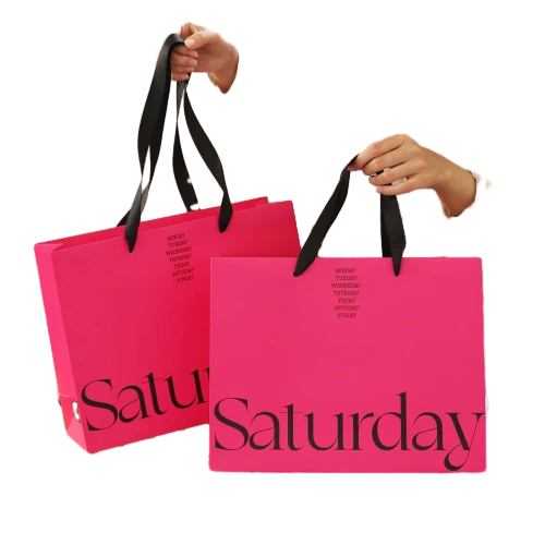Special Craft Paper Bags adopt eye catching hot pink paper printed with elegant black week text and large Saturday font. Smooth black wide ribbon handles offer comfortable grip and great loading capacity. Thick premium craft paper keeps the bag rigid and maintains neat shape. The vibrant bright pink creates trendy modern style to attract customer attention for retail and gift giving. We support custom bag size base color printed text and brand logo. These paper bags fit fashion boutique shopping cosmetic packaging birthday gifts and holiday gift sets.