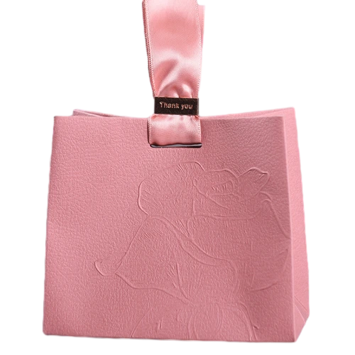 Special Craft Paper Bags feature delicate matte pink paper with beautiful embossed rose pattern on surface. Soft pink satin ribbon handle matches with metal Thank you tag to show warm elegant taste. Thick premium craft paper maintains good shape and solid structure. Embossing craft brings distinct tactile texture without extra ink printing. We support custom bag size embossed pattern logo and surface color. These paper bags are great for wedding favors cosmetic gifts jewelry packaging birthday and holiday gift sets.
