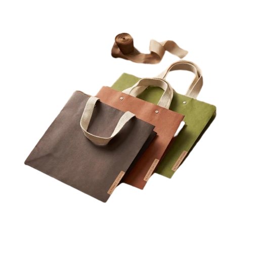 Special Craft Paper Bags come in multiple vintage earth tone colors with matte textured surface. Natural cotton webbing handles are soft and durable for daily carrying. Decorative leather label and metal snap button enhance the retro aesthetic and secure closure. Thick paper material maintains stable shape and good loading capacity. Muted color palette brings simple natural style favored by fashion and lifestyle brands. We support custom bag size printed logo leather tag content and surface color. These paper bags fit apparel store shopping gift packaging retail merchandise birthday and holiday gift sets.