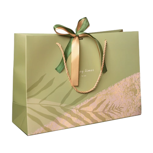 Special Craft Paper Bags adopt soft sage green base decorated with subtle translucent leaf silhouette and textured blush pink graphic. Gold twisted rope handles bring solid load bearing capacity. Two tone satin bow in green and gold ties on top to deliver gentle natural aesthetic. Thick premium craft paper maintains upright bag shape for repeated use. Delicate cursive text is printed on front to upgrade premium gift feeling. We support custom bag size printed pattern text and brand logo. These paper bags fit tea packaging cosmetic gifts birthday presents wedding favors and holiday gift sets.