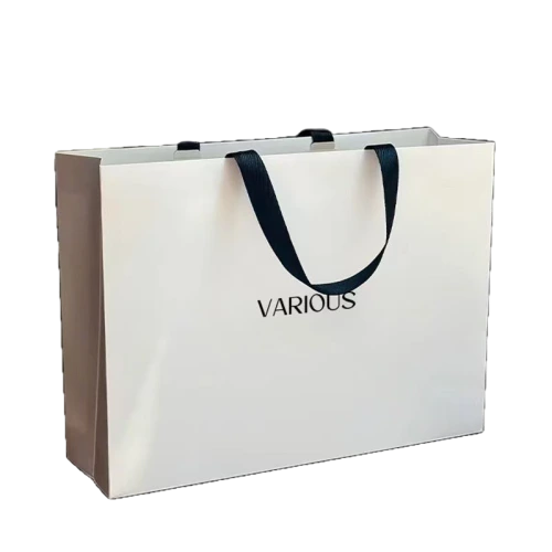 Special Craft Paper Bags adopt clean cream white paper surface printed with minimalist black VARIOUS serif letter. Matching black wide ribbon handles are soft sturdy and comfortable for hand carrying. Thick premium craft paper keeps the bag upright and maintains neat shape. The simple high contrast design creates understated luxury style suitable for all brand images. We support custom bag size base color printed text and brand logo. These paper bags fit fashion boutique shopping cosmetic packaging apparel stores birthday gifts and holiday gift sets.