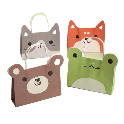 Coated Art Paper Bags feature lovely die cut animal ear designs including bear cat frog and fox. The smooth coated paper surface presents bright vivid cartoon prints. Equipped with sturdy paper handles for easy carrying. These bags are perfect for kids birthday party baby shower candy and small toy packaging. We support custom size custom pattern and custom logo printing to match your party and brand needs. Bulk wholesale is available.