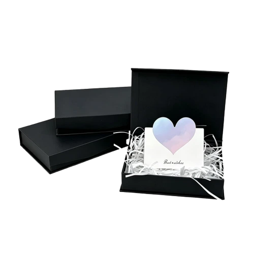 This minimalist matte black custom rigid magnetic box has a smooth non gloss outer and inner surface. The large inner space can hold shredded paper filler greeting cards and different kinds of gift items. Built in magnet ensures easy opening and tight closure. Heavy duty rigid cardboard keeps the box firm and delivers a high end unboxing experience. You can customize logo printing exterior patterns inner lining colors and box dimensions. It fits well for anniversary gifts wedding favors birthday hampers cosmetic sets and luxury brand retail packaging.