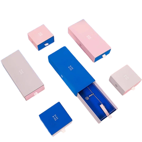 This set of slide drawer custom cardboard boxes is available in multiple square and rectangular sizes to fit different kinds of jewellery. The outer cover uses elegant twotone color matching with pink blue and light grey options. Soft velvet lining inside protects necklaces rings earrings and bracelets against scratches. Minimal debossed brand logo is printed on the top surface for subtle high end branding. The smooth pullout drawer structure provides easy access to stored items. You can change outer colors inner lining material logo style and outer dimensions. It fits well for necklaces rings earrings bracelets jewelry gifts and luxury small accessory packaging.